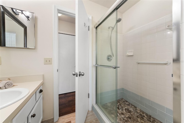 bathroom featuring a stall shower and vanity