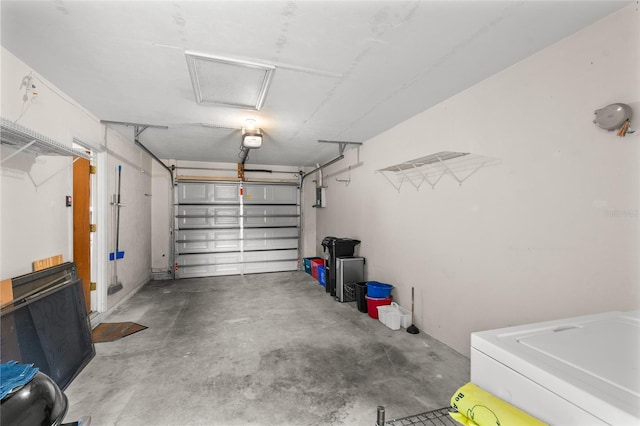 garage with washer / dryer and a garage door opener