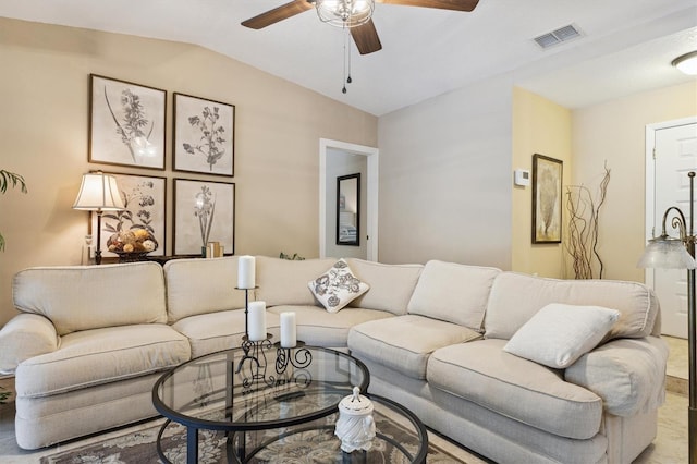 living area featuring lofted ceiling, ceiling fan, and visible vents