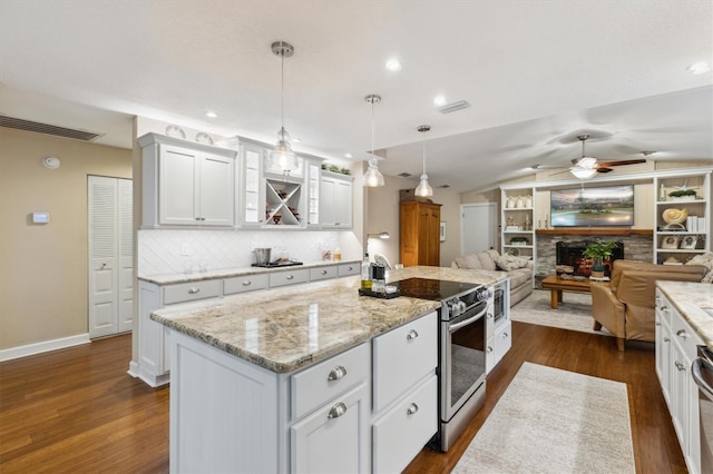 kitchen featuring white cabinets, open floor plan, electric stove, an island with sink, and dark wood finished floors