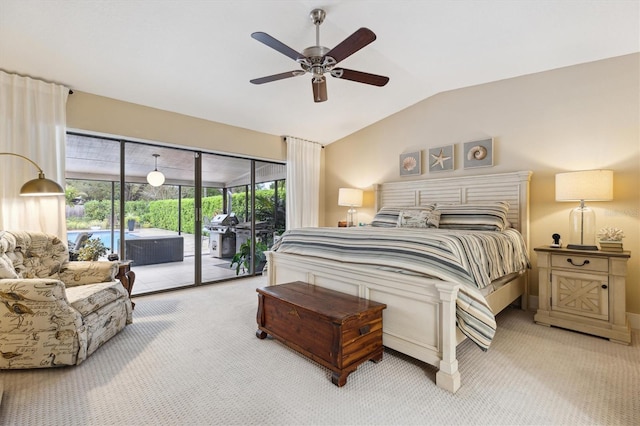 carpeted bedroom featuring access to outside, vaulted ceiling, and ceiling fan