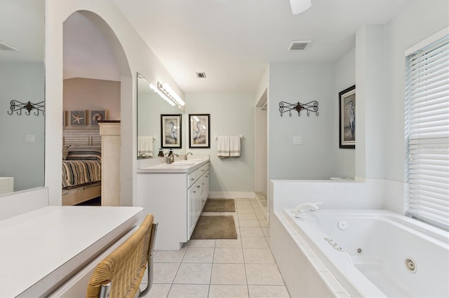 bathroom with a whirlpool tub, vanity, visible vents, and tile patterned floors