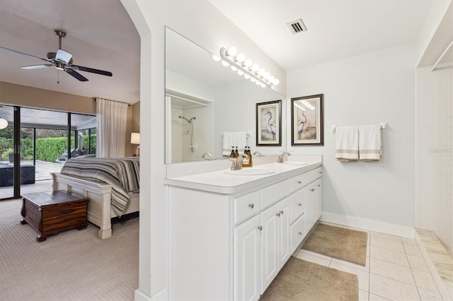 bathroom featuring visible vents, a ceiling fan, a sink, ensuite bath, and tile patterned floors