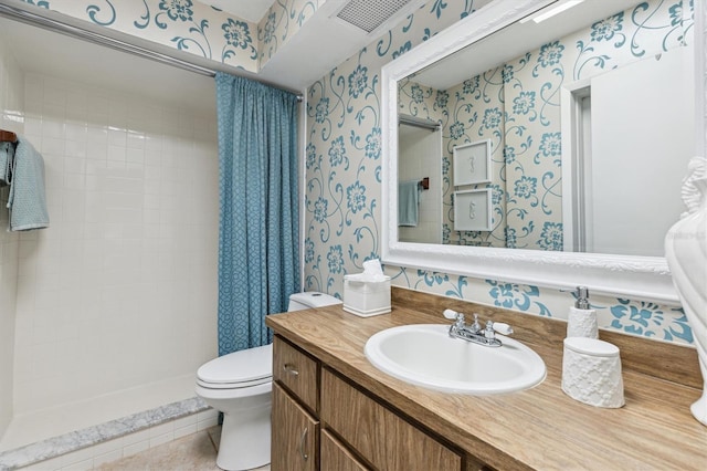 full bathroom featuring wallpapered walls, toilet, a tile shower, vanity, and tile patterned floors