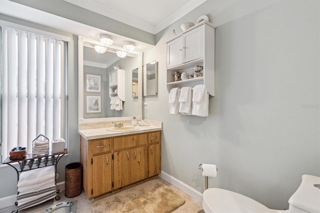 bathroom with ornamental molding, baseboards, vanity, and toilet