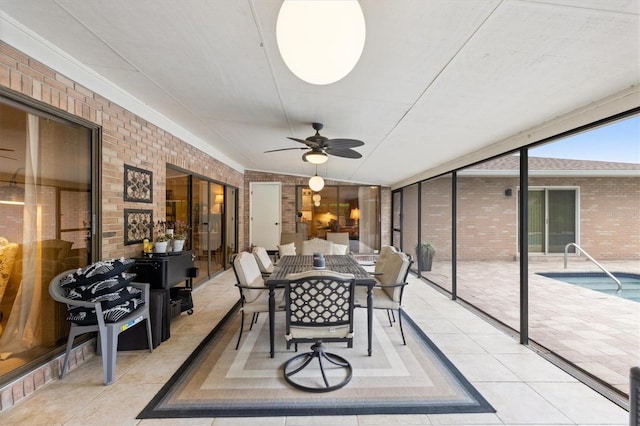 sunroom / solarium featuring ceiling fan