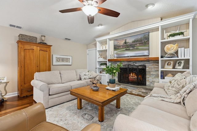 906 Crestview Dr, Auburndale, FL 33823 - living room with lofted ceiling, wood finished floors, a ceiling fan, and a stone fireplace