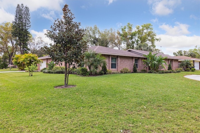 906 Crestview Dr, Auburndale, FL 33823 - single story home with a front lawn, brick siding, and a garage