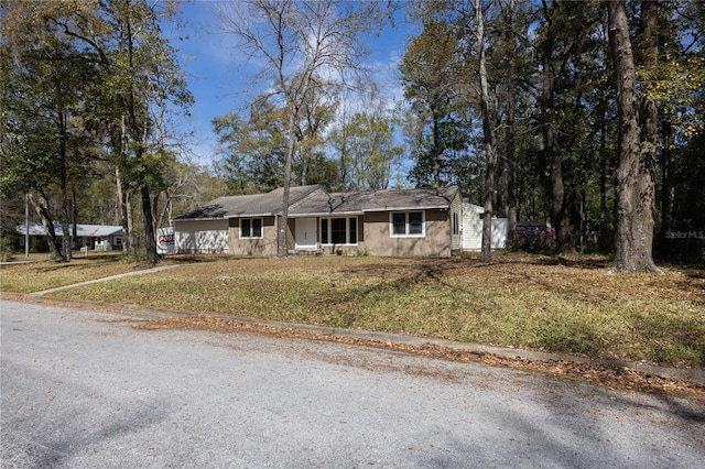 ranch-style house with a garage, driveway, and a front yard