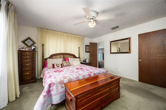 carpeted bedroom with ceiling fan, visible vents, and baseboards