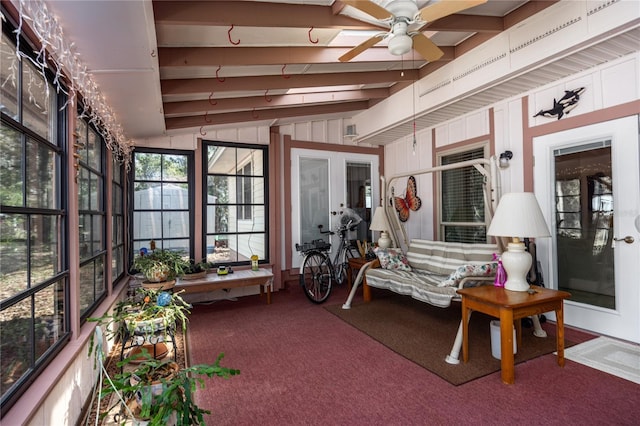 sunroom with ceiling fan and beam ceiling