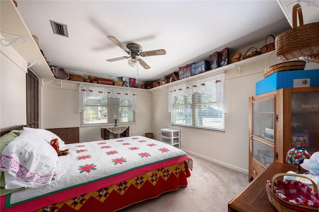 bedroom featuring baseboards, carpet floors, visible vents, and a ceiling fan