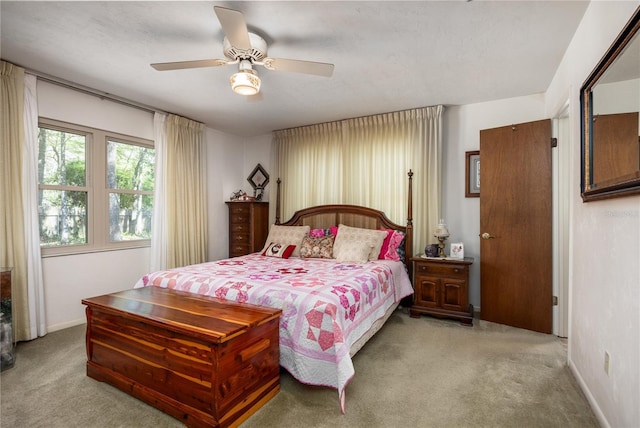 bedroom with carpet, a ceiling fan, and baseboards