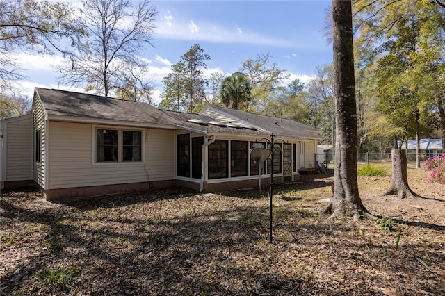 back of house with a sunroom and fence