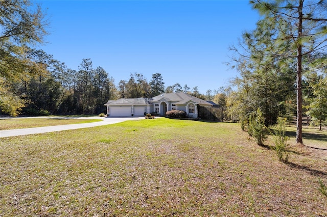 view of front of home with a garage, driveway, and a front lawn