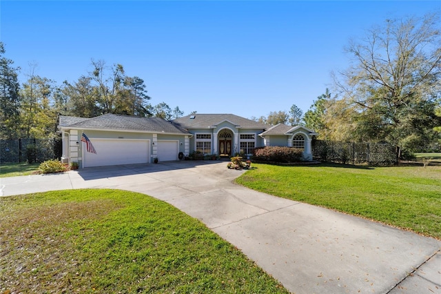 view of front facade with a front lawn, fence, driveway, and an attached garage