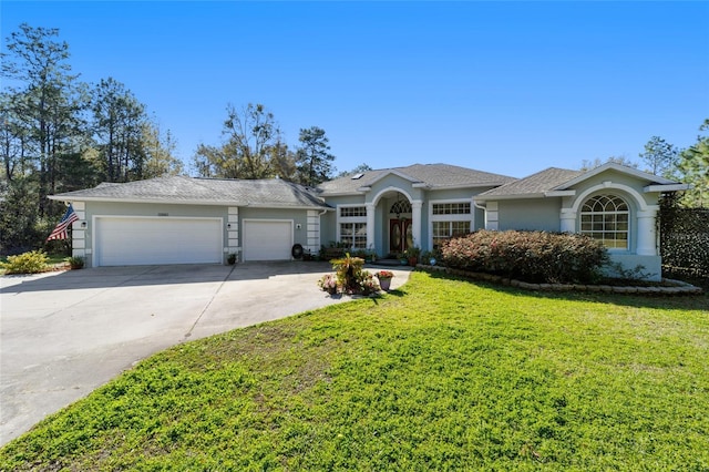 view of front of house featuring a garage, a front yard, concrete driveway, and stucco siding