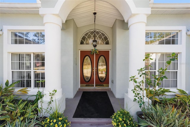 doorway to property featuring stucco siding