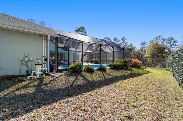 view of yard with a lanai, a fenced backyard, and an outdoor pool