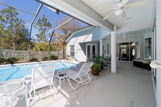 view of patio / terrace featuring a lanai, a fenced in pool, a ceiling fan, and french doors