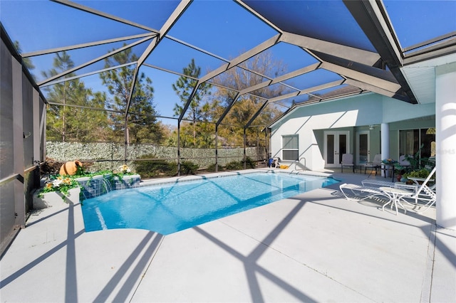 view of swimming pool with a fenced in pool, glass enclosure, french doors, and a patio area