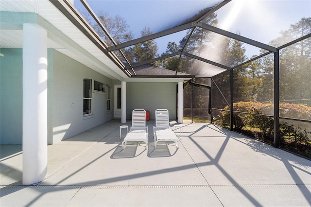 view of patio featuring a lanai