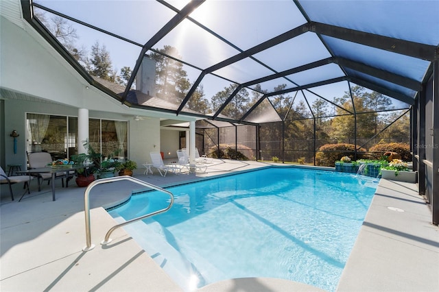 pool with glass enclosure and a patio area