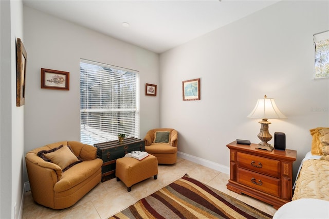 living area featuring light tile patterned floors and baseboards