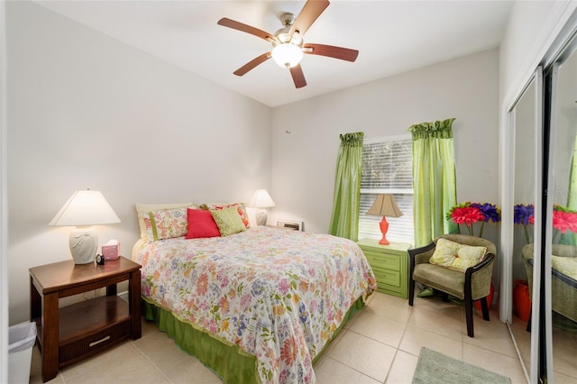 bedroom featuring a closet, light tile patterned flooring, and a ceiling fan