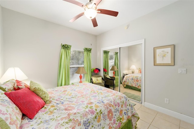 bedroom with baseboards, a closet, a ceiling fan, and tile patterned floors