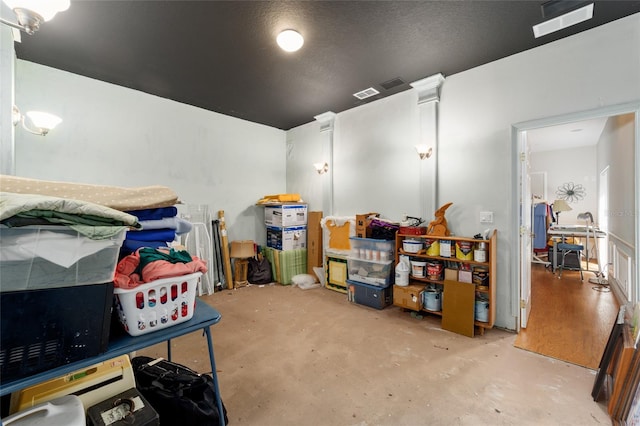 cinema room with visible vents and concrete flooring