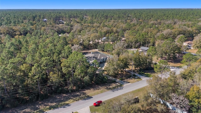 drone / aerial view featuring a view of trees