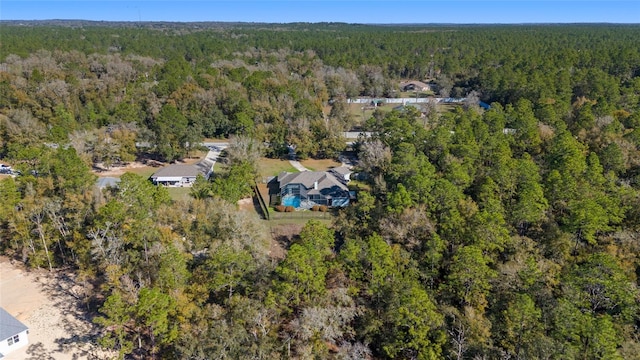 birds eye view of property featuring a wooded view