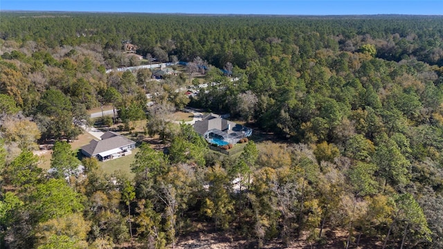 drone / aerial view featuring a forest view