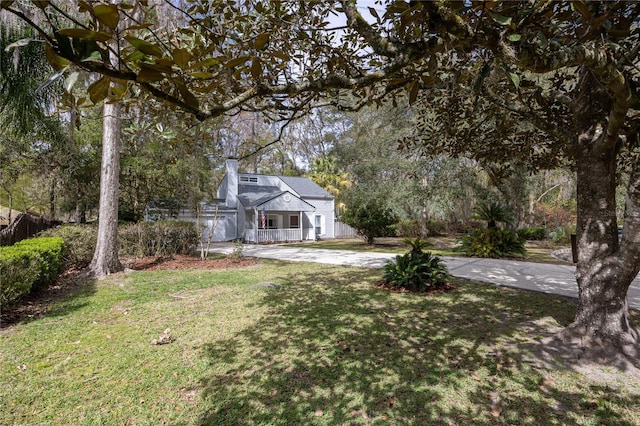 view of front of house with concrete driveway and a front lawn