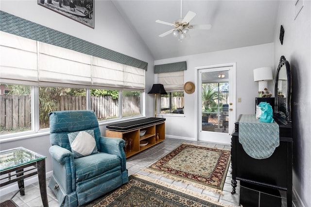 living area with tile patterned flooring, baseboards, vaulted ceiling, and a ceiling fan