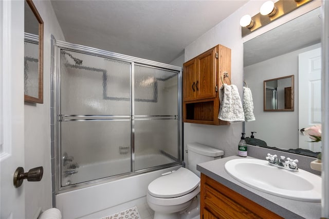 full bath featuring combined bath / shower with glass door, vanity, and toilet