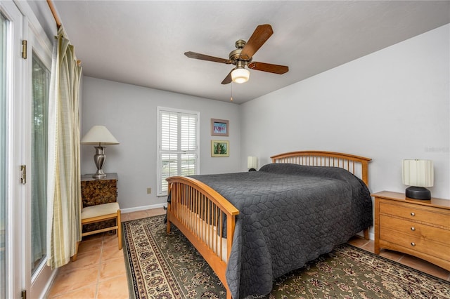 bedroom with light tile patterned floors, baseboards, and a ceiling fan