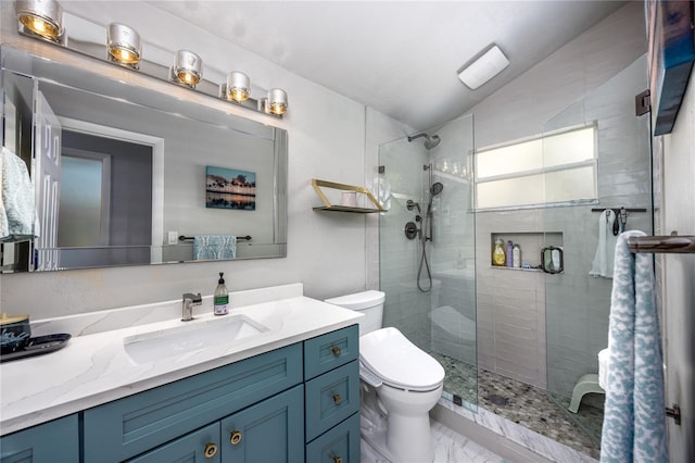 bathroom featuring a stall shower, toilet, lofted ceiling, marble finish floor, and vanity