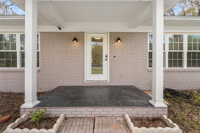 entrance to property with brick siding