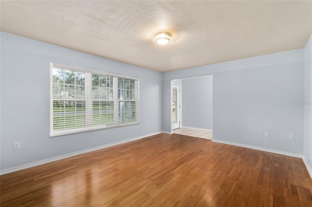 empty room with wood finished floors and baseboards