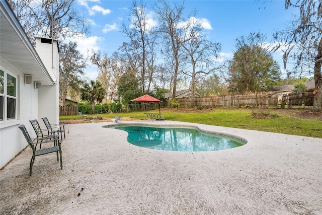 view of pool featuring a patio, a lawn, a fenced backyard, and a fenced in pool