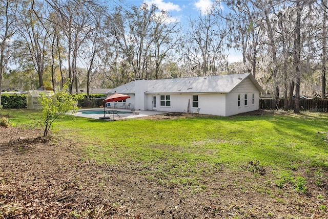 back of property featuring a patio area, a fenced backyard, a fenced in pool, and a lawn