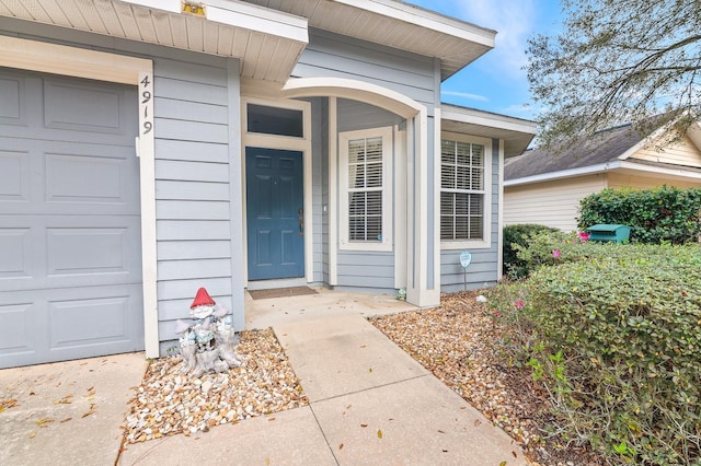 property entrance featuring an attached garage