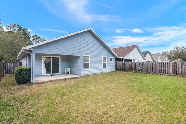 back of house featuring a yard, a fenced backyard, and a patio