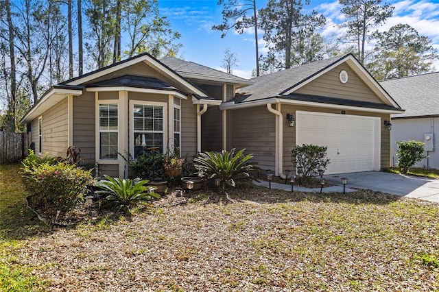 view of front of house with concrete driveway, fence, a garage, and a shingled roof