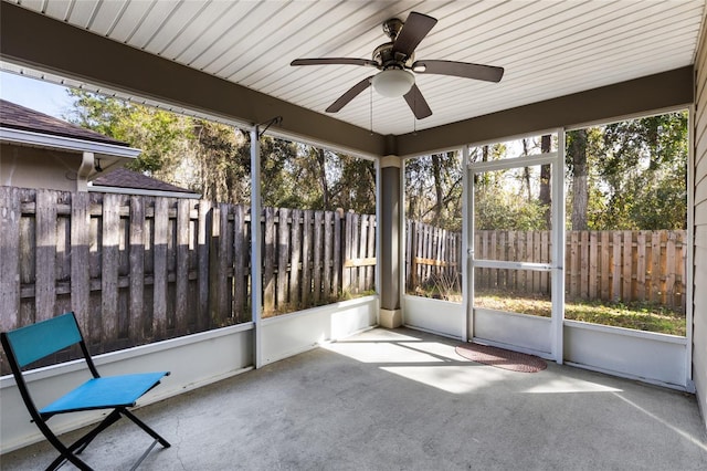 unfurnished sunroom with a wealth of natural light and a ceiling fan