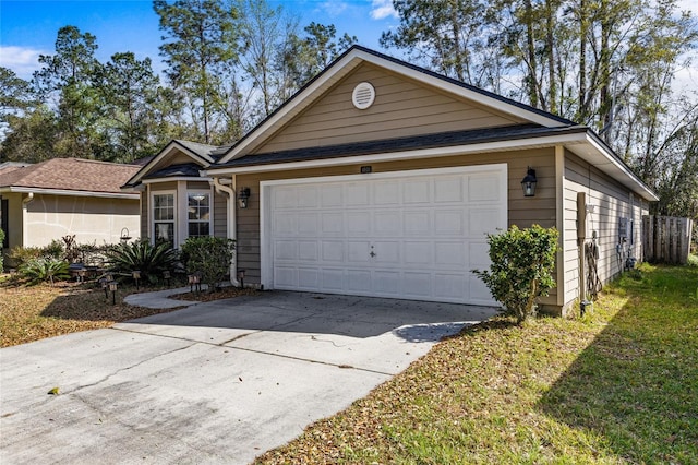 ranch-style house featuring concrete driveway and an attached garage