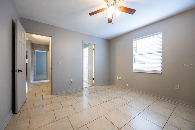 unfurnished bedroom with ceiling fan, baseboards, and light tile patterned flooring