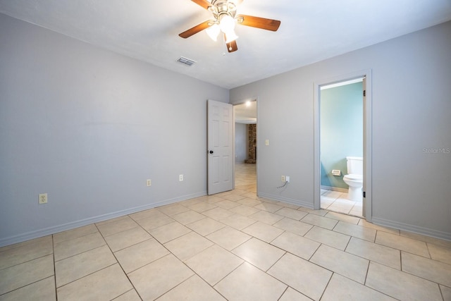 unfurnished bedroom featuring a ceiling fan, visible vents, baseboards, and light tile patterned floors